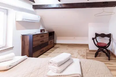 a bedroom with a bed and a wooden dresser at Apartment Grič with Sauna in Stari Trg pri Ložu