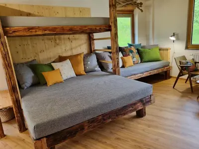 a living room with a couch with pillows on it at Studio Apartma2 pri Adamu in Mislinja