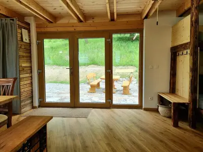 a living room with sliding glass doors and a patio at Studio Apartma2 pri Adamu in Mislinja