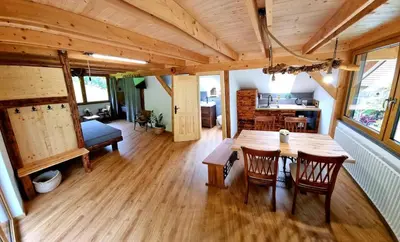 a large room with a wooden table and chairs at Studio Apartma2 pri Adamu in Mislinja