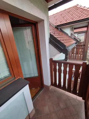 a balcony of a house with a wooden door at Apartma Valerija in Zreče