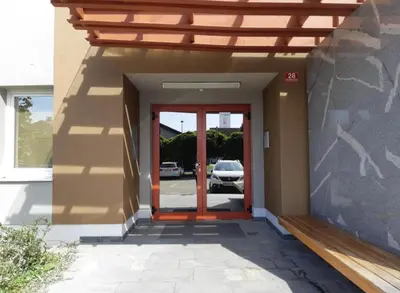 a entrance to a house with a wooden door at Sunflower Apartment Moravske Toplice in Moravske Toplice