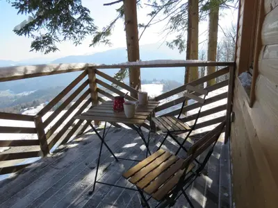 a table and two chairs on a porch with a view at Turistična kmetija Okršlan in Škofja Loka