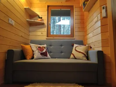 a blue couch in a room with a window at Turistična kmetija Okršlan in Škofja Loka