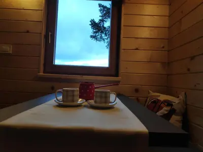 two cups on a table in a room with a window at Turistična kmetija Okršlan in Škofja Loka