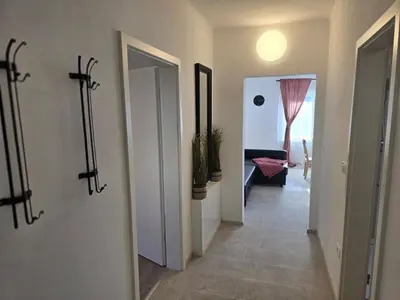 a hallway with two doors and a hallway with a room with at Apartment Barje II, bright&sunny, private parking in Ljubljana