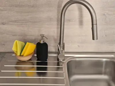 a kitchen sink with a faucet and a sink at Apartment Barje II, bright&sunny, private parking in Ljubljana