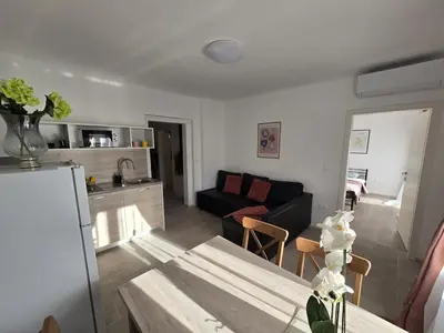 a living room with a couch and a table at Apartment Barje II, bright&sunny, private parking in Ljubljana