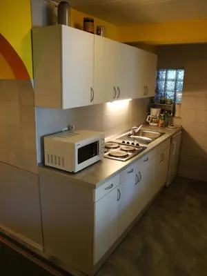 a kitchen with a microwave on top of a counter at Blumauer Apartments in Ljubljana