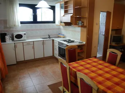 a kitchen with a table and a stove top oven at Blumauer Apartments in Ljubljana