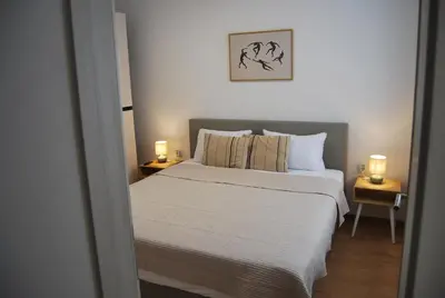 a bedroom with a bed and two lamps on tables at Apartma Rače in Rače