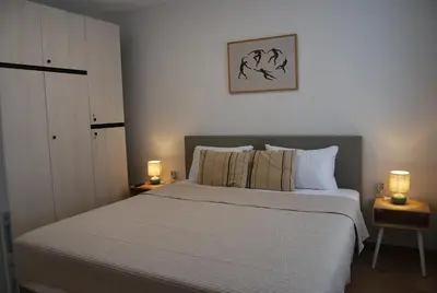a bedroom with a large bed with two lamps on tables at Apartma Rače in Rače