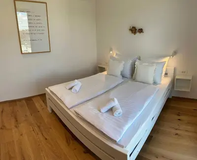 a bedroom with a bed with two towels on it at Angel Wings premium apartment in Ljubljana