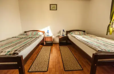 two beds sitting next to each other in a room at Apartment House Sumrak in Bizeljsko