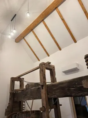 a ceiling with wooden beams and a ladder in a room at Ana&Borl House in Gradišča