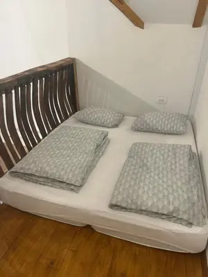 a large white bed with two pillows on it at Ana&Borl House in Gradišča