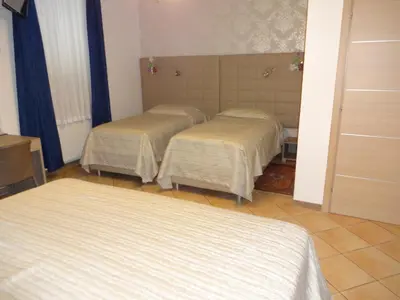 a room with three beds in a room at Fedrig Private Rooms & Apartment in Kobarid