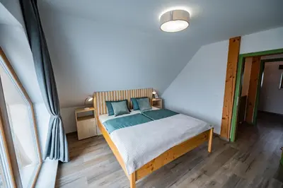 a bedroom with a bed with blue pillows at Vineyard cottage Kraljevi kotiček in Trebnje