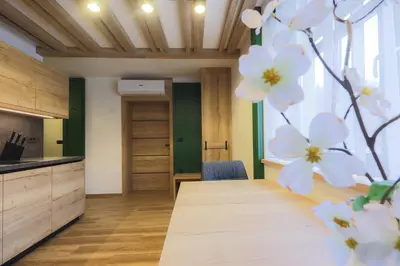 a kitchen with a table and white flowers at Vila Savica Bled in Bled