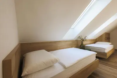a attic bedroom with two beds and a skylight at Vila Savica Bled in Bled