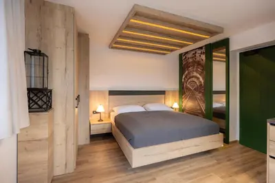 a bedroom with a large bed and a green door at Vila Savica Bled in Bled