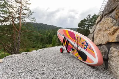 a surfboard sitting on the side of a rock at Pine Hill RUBY with free jacuzzi in Rakitna