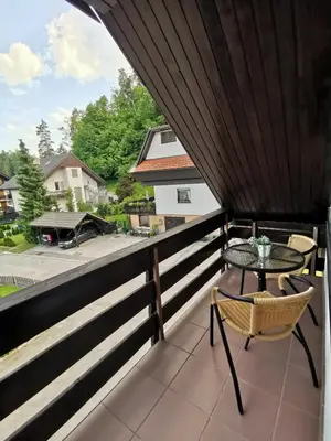 a balcony with a table and chairs and a view at Bled Veldes in Bled