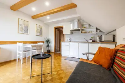 a kitchen and a living room with a couch and a table at Bled Veldes in Bled