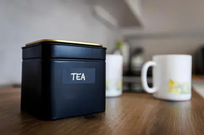 a black container sitting on a table next to a cup at Bled Veldes in Bled