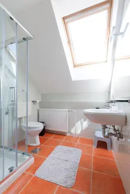 a bathroom with a sink and a toilet and a window at Bled Veldes in Bled