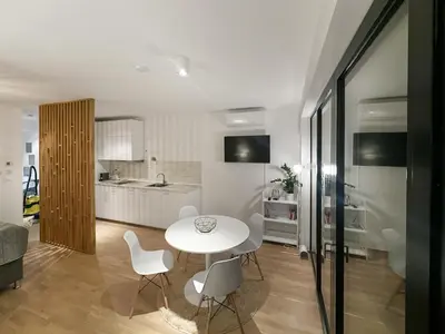 a kitchen and living room with a table and chairs at Apartment number 7 in Ljubljana