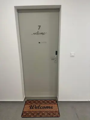 a door with a welcome mat in front of it at Apartment number 7 in Ljubljana