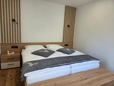 a bedroom with a bed with pillows on it at Vila Natalia in Kranjska Gora