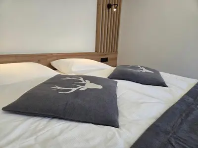a bed with two pillows on top of it at Vila Natalia in Kranjska Gora