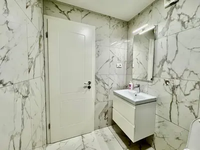 a white bathroom with a sink and a mirror at Vila SofiOmi in Bled