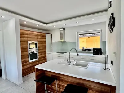 a kitchen with a sink and a stove top oven at Vila SofiOmi in Bled