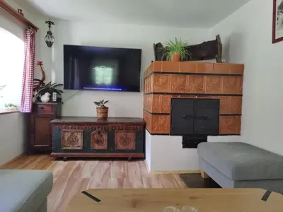 a living room with a fireplace and a flat screen tv at Chalet Vrsnik Hideaway in Soča