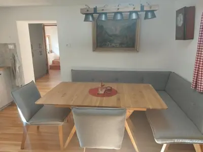 a dining room table with chairs and a wooden table at Chalet Vrsnik Hideaway in Soča