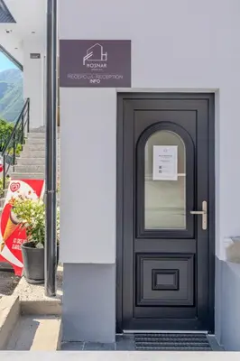 a black door with a sign on a building at Pension Hosnar, apartma Gusto in Bovec