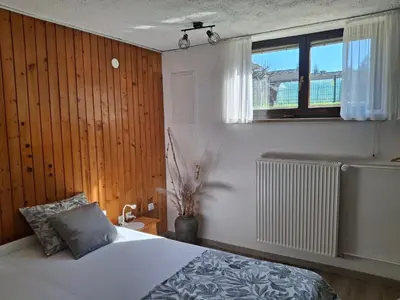 a bedroom with a white bed and a window at Prenočišče Breza in Radovljica