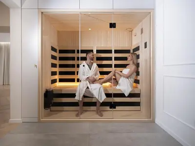 a man and a woman sitting in a display window at Trend Apartment in Ormoz