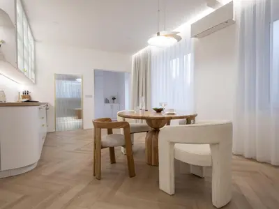 a kitchen and dining room with a table and chairs at Trend Apartment in Ormoz