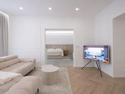 a living room with a couch and a flat screen tv at Trend Apartment in Ormoz