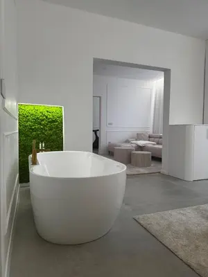 a large white bath tub in a living room at Trend Apartment in Ormoz