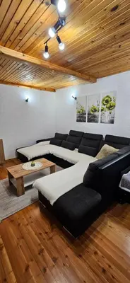 a living room with a large bed and a couch at Počitniška hiša Alica in Črna na Koroškem
