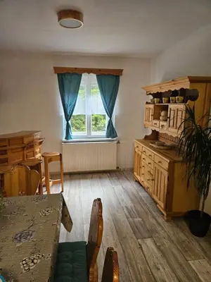 a living room with a table and a window at Počitniška hiša Alica in Črna na Koroškem