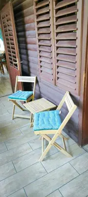 two chairs and a table on a patio at Počitniška hiša Alica in Črna na Koroškem