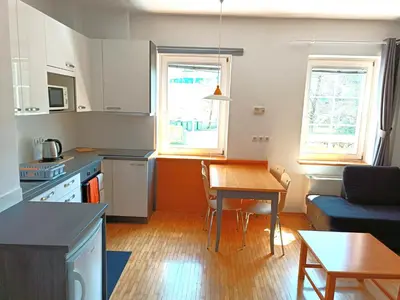 a kitchen and a living room with a table at Apartma Angela Bled in Bled
