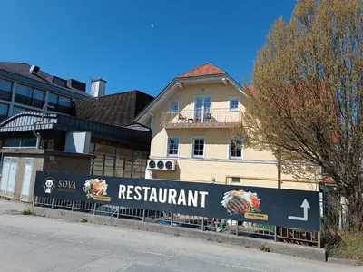 a sign for a restaurant in front of a building at Apartma Angela Bled in Bled