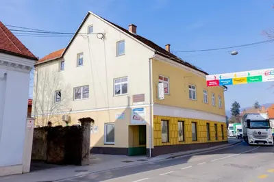 a white truck parked in front of a building at Soba Pri Kosu in Slovenska Bistrica